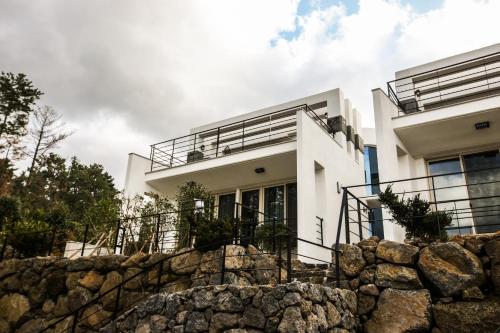 a white house with a stone wall at The Stay Christmas in Jeju