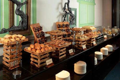 a buffet with many different types of bread and pastries at Jetwing Blue in Negombo