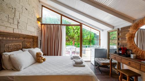 a bedroom with a bed with a teddy bear sitting on it at Lulu Inn Cesme in Çeşme