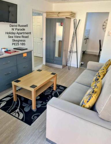 a living room with a couch and a coffee table at North Parade Holiday Apartment 35 Sea View Road Skegness PE25 1BS in Skegness