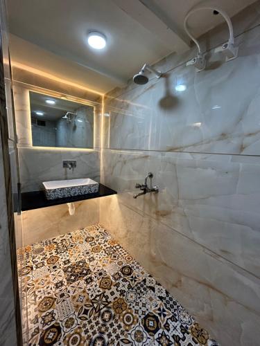 a bathroom with a sink and a mirror at Max Guest House in Agra