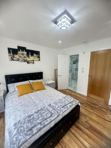 a bedroom with a bed and a glass shower at Tina guest house in London