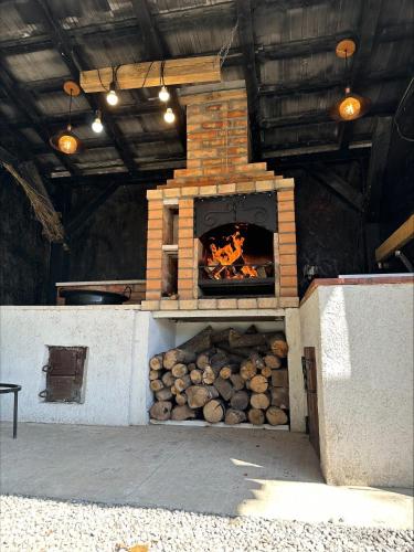 a brick oven with a fire inside of it at Flow House in Satu Mare