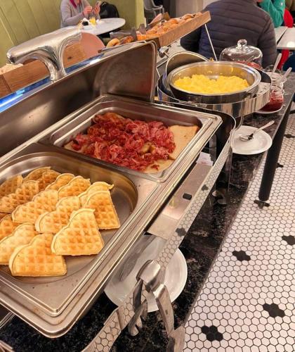 a buffet with waffles and other food on a table at ibis Pilar in Pilar