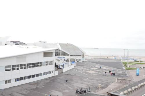 un parking vide à côté d'un bâtiment et de la plage dans l'établissement OPARADI 