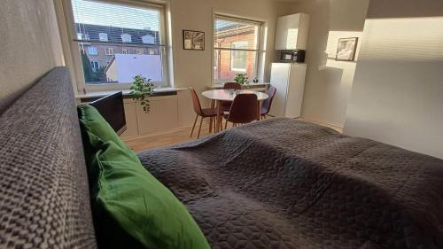 a bedroom with a bed and a table in a room at Free Parking Center Of The City Studio Aalborg in Aalborg