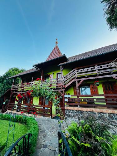 a house with a yellow at Casa de vacanță Trei Zâne in Sovata
