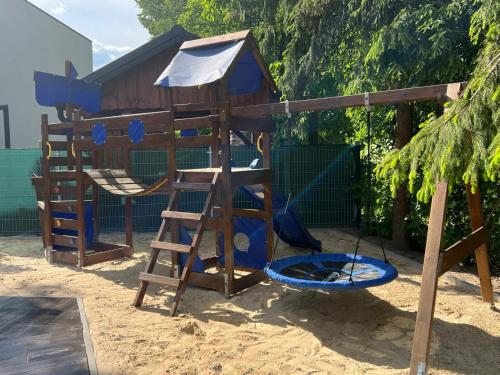 a playground with a ladder and a play structure at Osada Rybacka in Włodawa