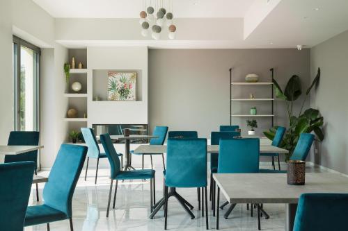 a dining room with blue chairs and tables at Casale Auriga - Oltrepo' Pavese in Codevilla