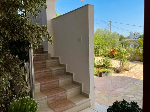 a stairway leading up to a home with a staircase at Jeti Guesthouse in Ksamil