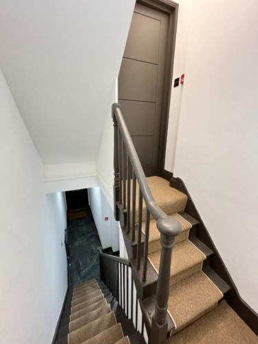 a staircase in a house with a door and a stair case at Fabulous 3 Bed Apartment - Near Excel - Sleeps 6 - 8 in London