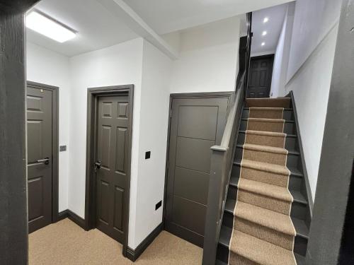 a staircase in a hallway with two doors and a stair case at Fabulous 3 Bed Apartment - Near Excel - Sleeps 6 - 8 in London