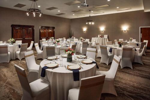 a banquet room with white tables and white chairs at Hilton Tapestry Collection, Hotel Don Fernando De Taos in Taos