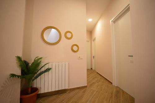 a hallway with a mirror and a potted plant at Labu Hotel in Tbilisi City