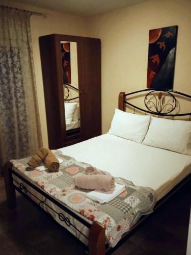 a bedroom with a bed with a mirror on it at Jenny's House in Yerakiní