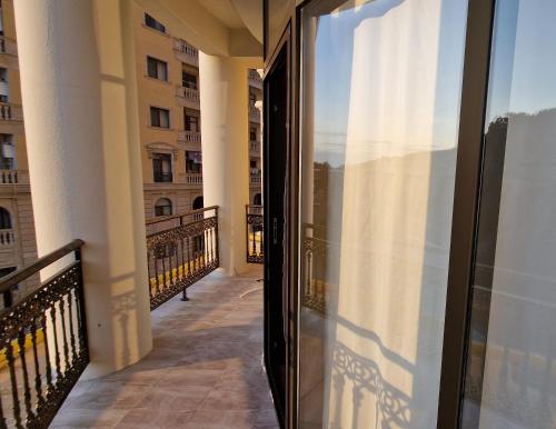 a balcony with a view of a building at Seaside Sumgait Apartment in Sumqayyt