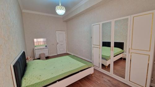 a bedroom with two beds and a tv in it at Seaside Sumgait Apartment in Sumqayyt