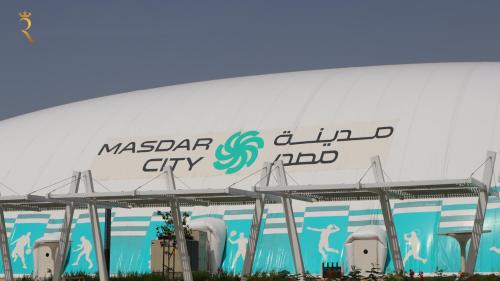 a large white building with the maserara city logo on it at Plush 2BR Retreat in Masdar City - Modern Stay Near Masdar Park & City Centre in Abu Dhabi