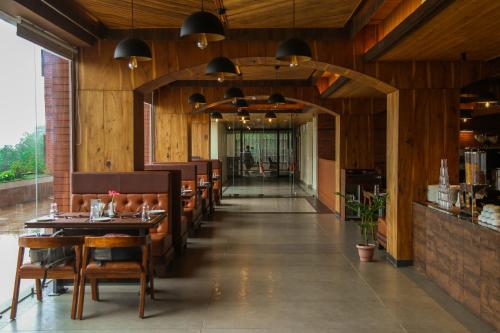 a restaurant with wooden walls and tables and chairs at Oro Montana Hotels and Resort in Gangtok