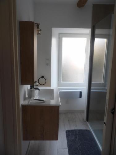 a bathroom with a sink and a window at La comprenance in Dourbies