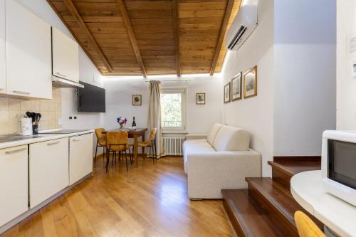 a kitchen and living room with a couch and a table at BolognaRoomscom - Frassinago Deluxe in Bologna