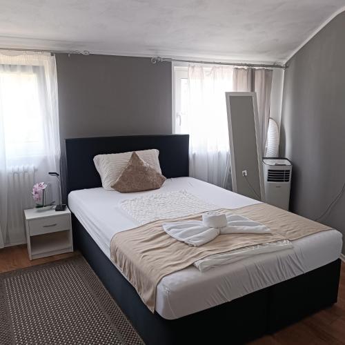a bedroom with a large bed with two towels on it at Hotel Ari in Kaiserslautern