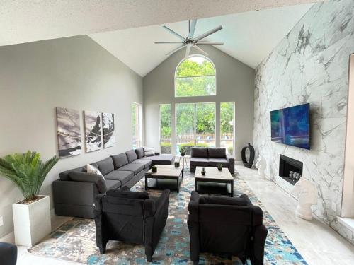 a living room with a couch and a stone wall at Captivating 6BR 3BA Holiday Home with Pool & Fire Pit in Mesquite