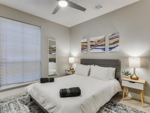 a bedroom with a large white bed and a window at Captivating 6BR 3BA Holiday Home with Pool & Fire Pit in Mesquite