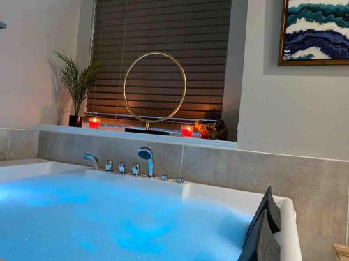 a large blue tub in a bathroom with a mirror at Captivating 6BR 3BA Holiday Home with Pool & Fire Pit in Mesquite
