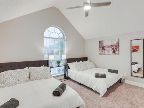 a bedroom with two beds and a window at Captivating 6BR 3BA Holiday Home with Pool & Fire Pit in Mesquite