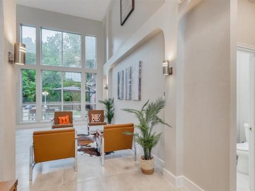 a living room with two chairs and a table at Captivating 6BR 3BA Holiday Home with Pool & Fire Pit in Mesquite