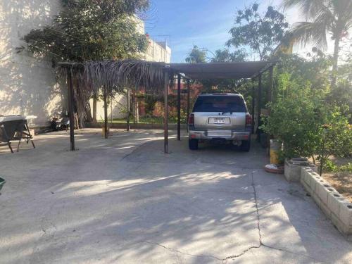 a car parked under a cover in a driveway at Bungalow And Surf in Cabo San Lucas
