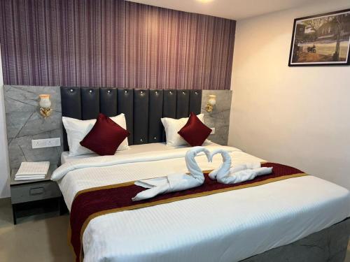 Postel nebo postele na pokoji v ubytování Hotel Orchard Park