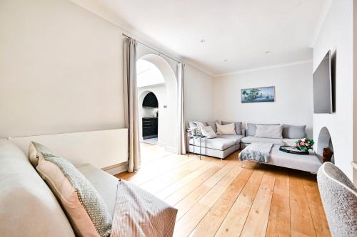 a living room with a couch and a table at New chic and luxury apartment in London