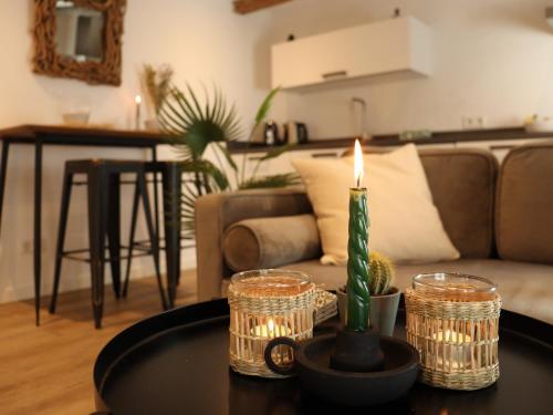 a candle on a table in a living room at Coolest Apartments in Haarlem City - close to Beach and Amsterdam in Haarlem