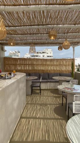 a patio with tables and chairs and a bar at TheCasaEdition Gauthier Residency City Center in Casablanca