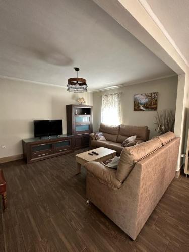 a living room with a couch and a tv at La Casa De La Abuela in Setenil