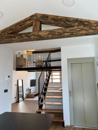 a staircase in a living room with wooden beams at Ferrol by Miramar Stays in Ferrol
