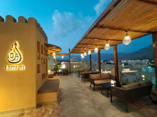 a rooftop bar with chairs and tables on a building at Durrat Nizwa Inn in Nizwa