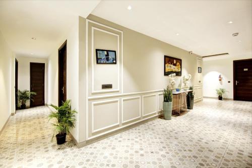 an empty lobby with a door and plants in it at Saltstayz Premier - Cyber Hub in Gurgaon