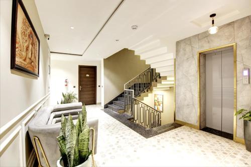 a living room with a couch and a staircase at Saltstayz Premier - Cyber Hub in Gurgaon