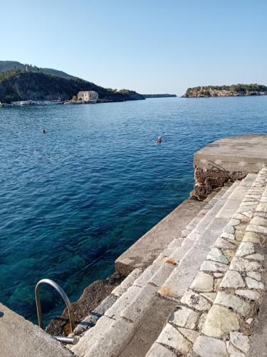 a view of a body of water from a pier at Olympia Koumanakou Rooms Δωμάτια Ολυμπίας Κουμανάκου in Kardamili