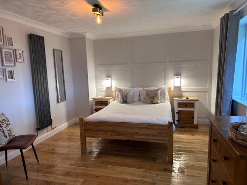 a bedroom with a bed and a desk and a chair at The Farmhouse at Fincham in Fincham