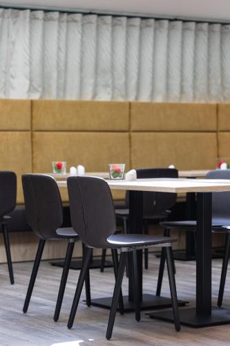 a table and chairs with cups on top of it at Best Western Hotel München Airport in Erding