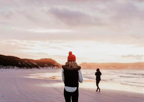 two people walking on the beach at sunset at Dutchen Park Weideduyn in Schoorl