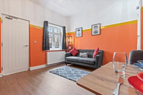a living room with a couch and a table at 4 Bedroom, 2 Bath in NewCastle Town Centre in Newcastle under Lyme