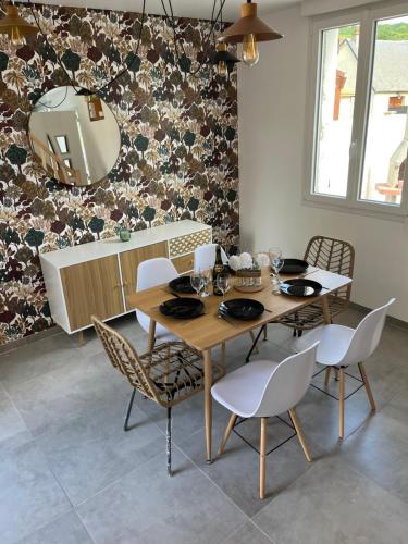 une salle à manger avec une table, des chaises et un miroir dans l'établissement Eau gîte, à Ponts-et-Marais