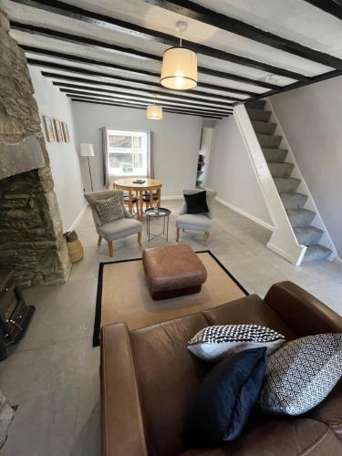 a living room with a couch and a table at The Cosy Cottage in Llanberis