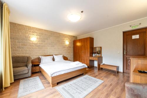 a bedroom with a bed and a couch in it at Resort EuroPark Fundata in Fundata