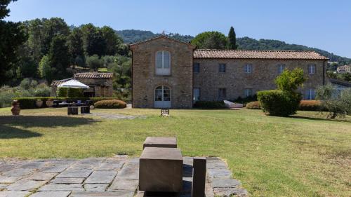a large brick building with a grassy yard at Villa Panorama 14, Emma Villas in Chianni